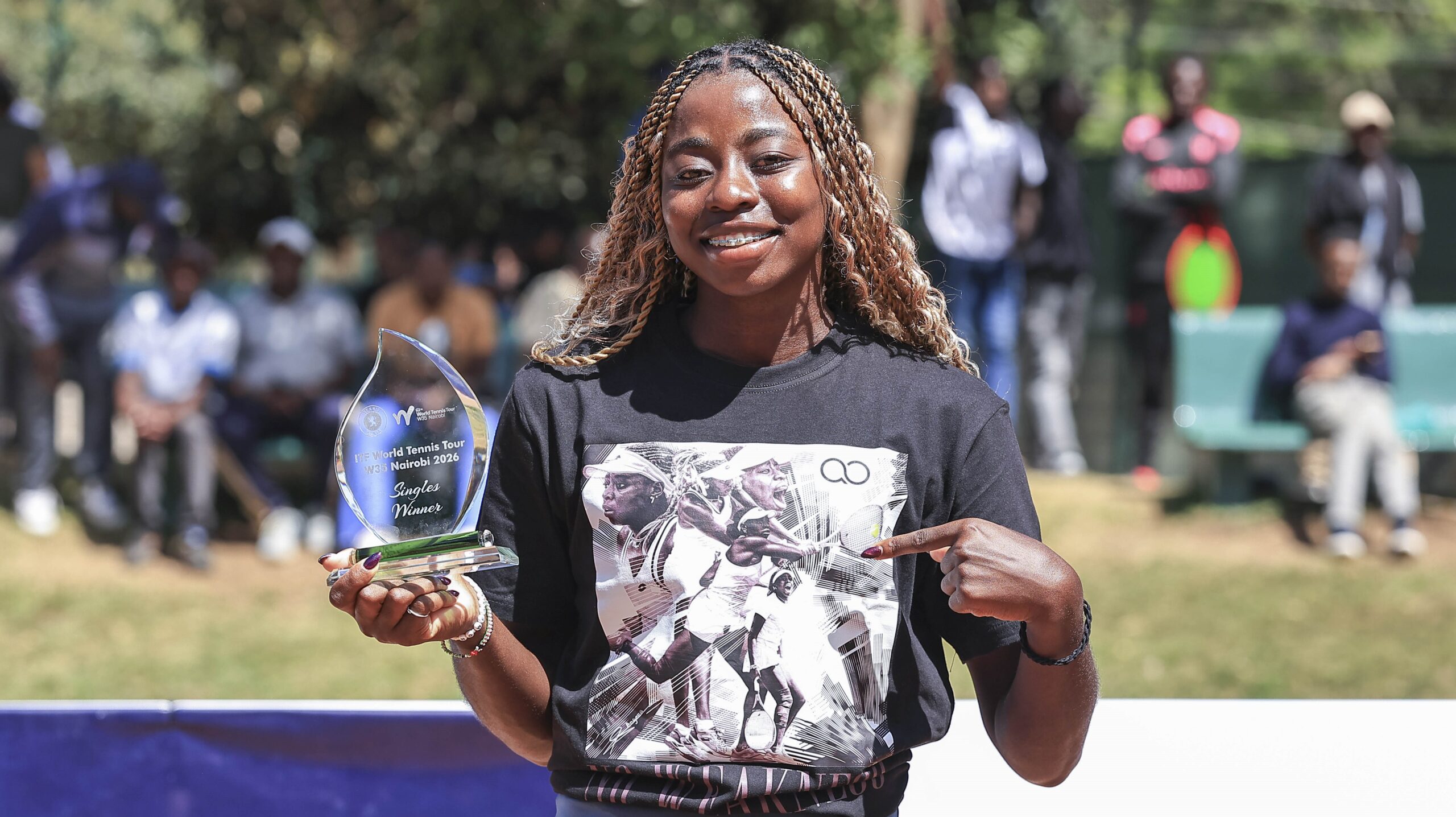 Angela Okutoyi, kenyan tennis player and Grand Slam, holding one of her ITF World tennis Trophy